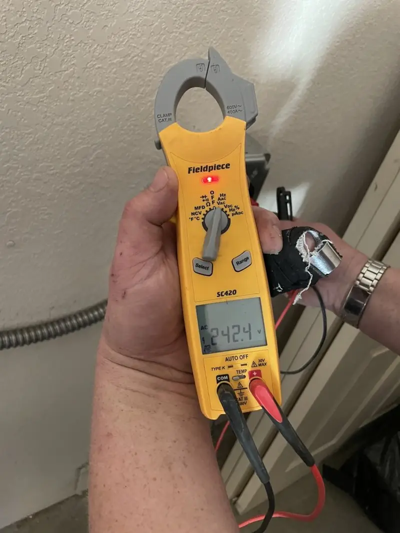 Voltage testing with clamp meter during Electrical Installation Services in North Branch